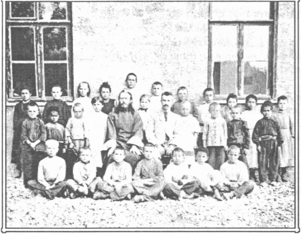 На этом снимке с учениками: заведующий школой грамотности — отец Павел (Ундольский) и его брат Н.В. Ундольский, учитель школы. 1904 год